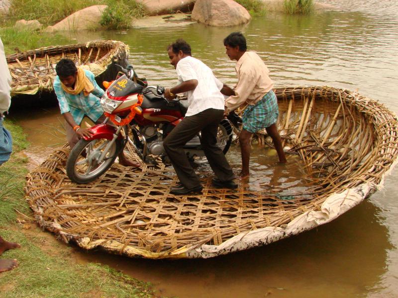 Passengers_Maneuver_Motorcycle_out_of_Reed_Boat_-_Near_Hampi_-_India.jpg